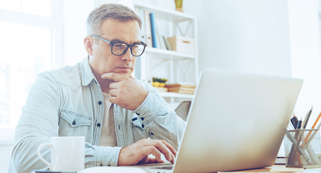 Man reviewing his account on computer.