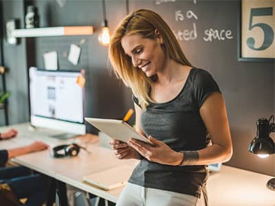 Woman using device to check website.