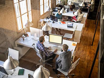 Two male business partners on computer at place of business