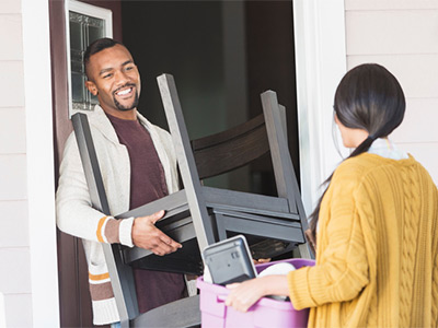 Black couple moving furniture.