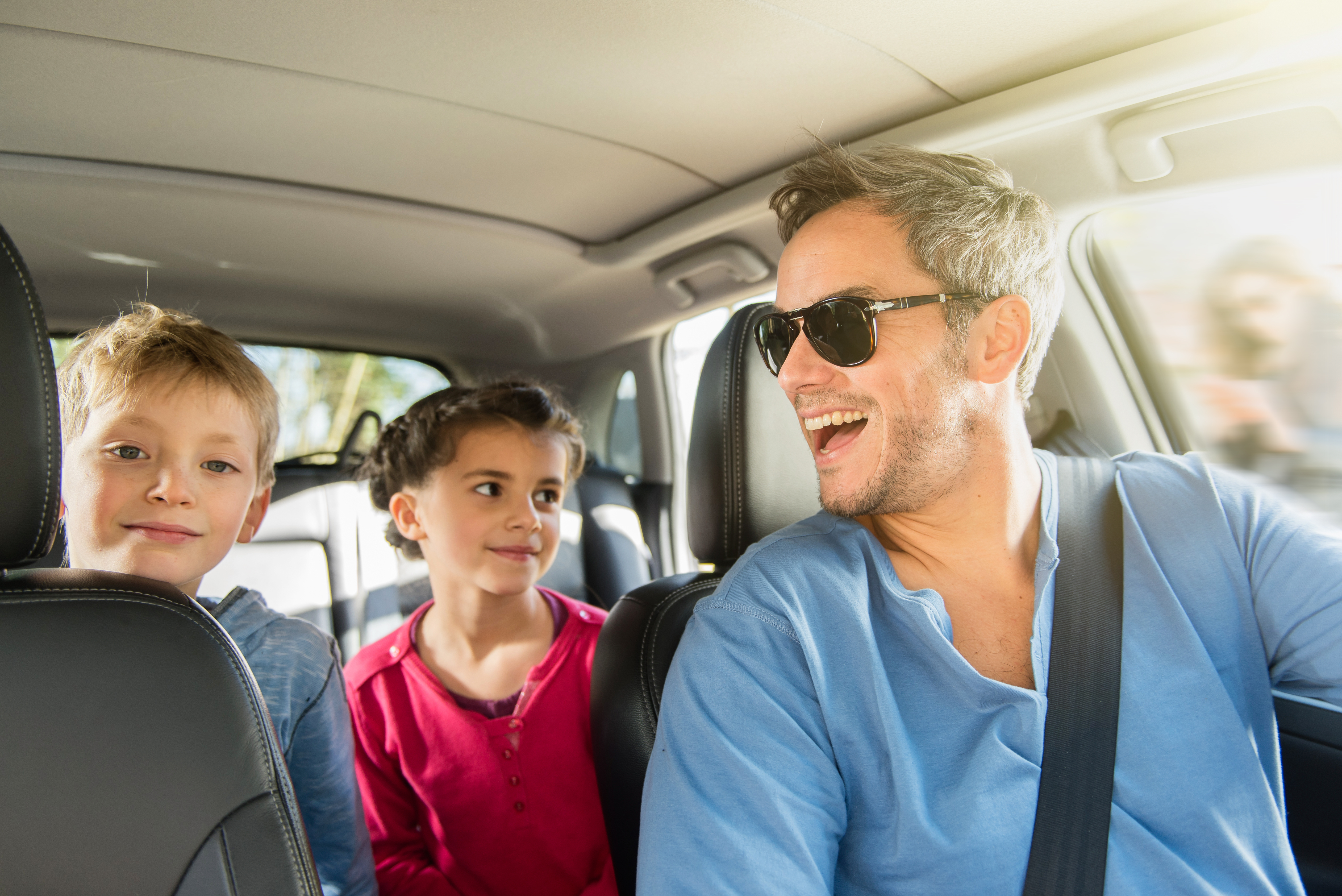 Car dealer handing keys to handsome male customer